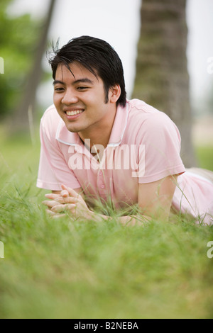 Young man lying on grass Stock Photo