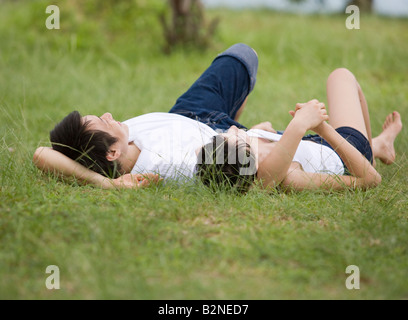 Young couple lying on grass Stock Photo