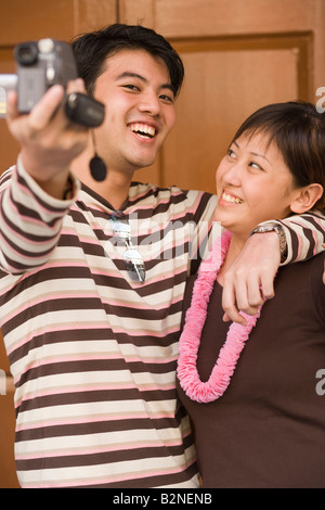 Young couple filming themselves Stock Photo