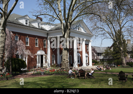 Colonial Club.  Large red brick house with two story white column entrance portico with decrative lintel. Stock Photo
