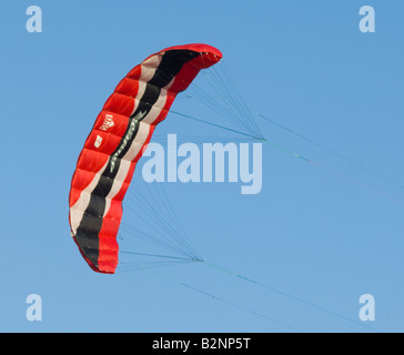 Red kite flying against blue sky Stock Photo