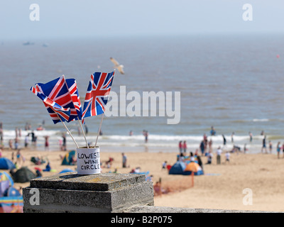 SMALL UNION JACK FLAGS WAVING IN BREEZE AT  LOWESTOFT DURING AIR DISPLAY,  WITH BEACH AND SEA BEHIND, SUFFOLK ENGLAND UK Stock Photo