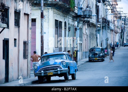 Street with old american vintage cars parked in the run down Centro district during the time of embargo Central Havana Cuba Stock Photo