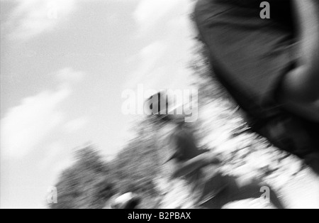 Palestinians run away from a attack by the I.D.F during a protest against the building of the separation barrier. Stock Photo