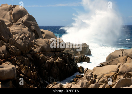 Wave crashing against rocks on the Capo Testa headland of North Sardinia Stock Photo