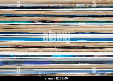 A stack of old worn magazines isolated against a white background Stock Photo