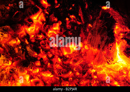Glowing embers of a fire turning molten Stock Photo