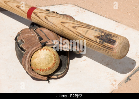 Baseball equipment sitting on home plate set up as a conceptual image Stock Photo