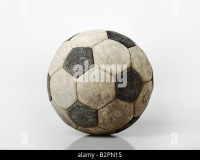 Worn soccer ball on white background cut out Stock Photo