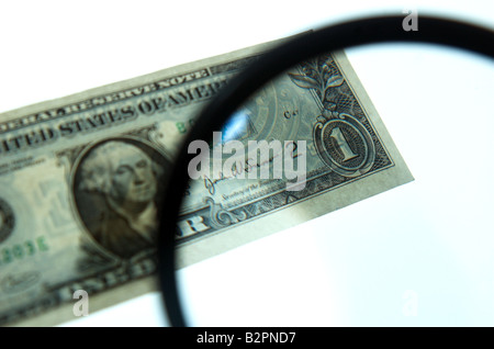 magnifying glass highlighting one dollar bill Stock Photo