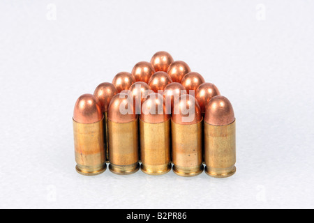 Bullets lined up at attention in the shape of a triangle on a white background Stock Photo