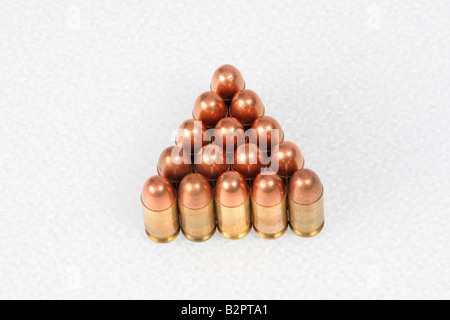 Bullets lined up at attention in the shape of a triangle on a white background Stock Photo