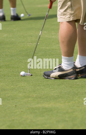 Close-up view of man on putting practice green Stock Photo