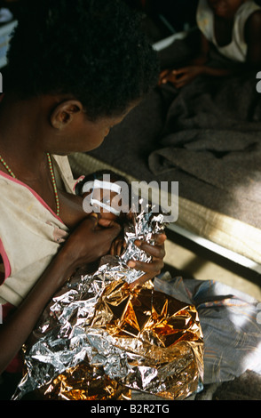 Woman breastfeeding baby, Angola, Africa Stock Photo