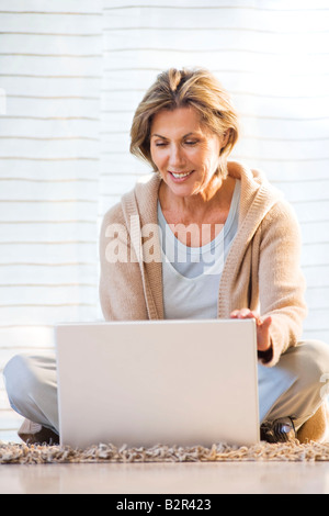 Woman Using Laptop At Home Stock Photo