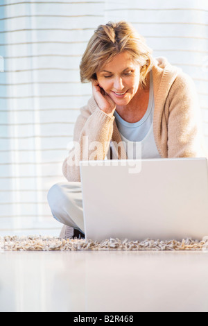 Woman Using Laptop At Home Stock Photo