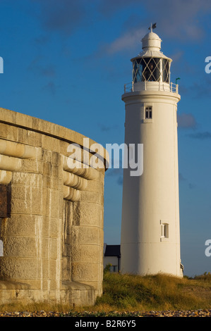 Hurst Castle and lighthouse in warm morning light with a blue sky Stock Photo