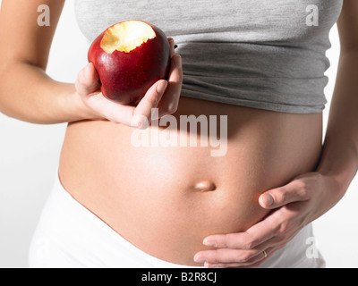 Pregnant woman with an apple Stock Photo