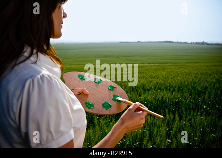 Woman holding painters palette Stock Photo