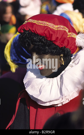 Zwarte Piet character during the annual Sinterklaas parade, a Dutch Christmas tradition. Amsterdam, Netherlands. Stock Photo