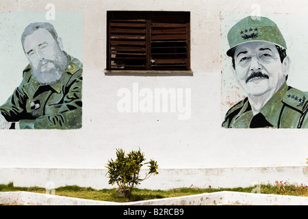 Wall paintings depicting Fidel left and Raul Castro in Baracoa, Cuba Stock Photo