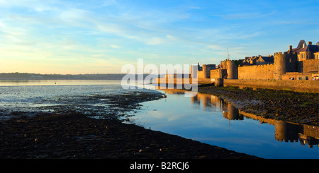 The outer walls of Caernarfon castle on the coast of North Wales in late evening sunshine Stock Photo