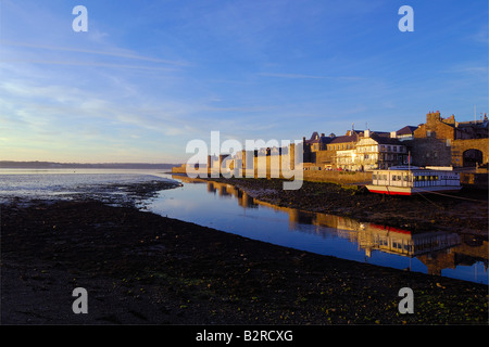 The outer walls of Caernarfon castle on the coast of North Wales in late evening sunshine Stock Photo