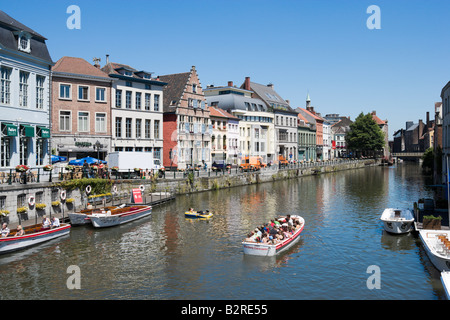 Excursion boat in front of traditional houses along the northern end of the Korenlei, Ghent, Belgium Stock Photo