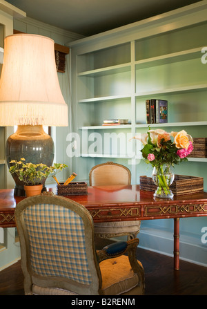 Small desk with chair and a large table lamp Stock Photo
