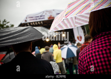 Rain falls but doesn't dampen spirits at a music festival. Stock Photo