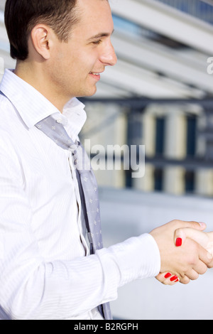 picture of handsome businessman shaking hands with female colleague Stock Photo