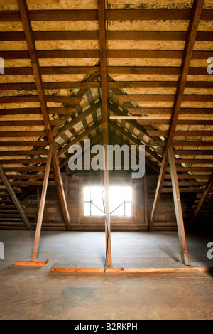Small window in an unfinished attic Stock Photo