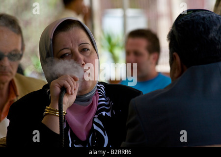 Woman Smoking a Nargileh in a Cafe in the Old City in Aleppo Syria Stock Photo