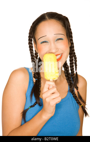 Portrait of young woman of Philippine origin with girlie make up holding a popsicle Stock Photo
