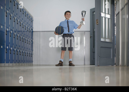 School boy with basketball and trophy Stock Photo
