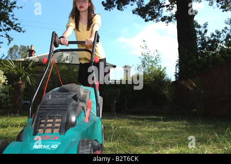 Teenage Girl Mowing the Lawn Model Released Stock Photo