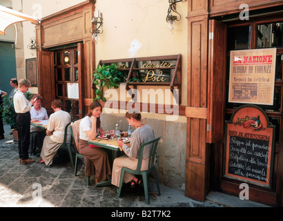 People sitting at outdoor tables having lunch at restaurant in Florence, Italy Stock Photo