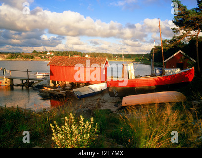 Red boat and boathouse near town of Stromstad Strömstad on West Coast of Sweden Stock Photo