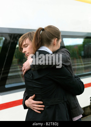 Couple embracing on train station Stock Photo
