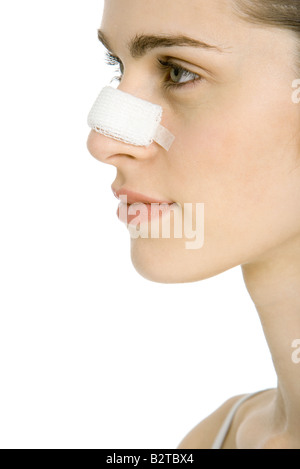 Young woman with bandaged nose, profile, cropped Stock Photo