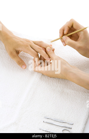 Person receiving manicure, cropped view of hands Stock Photo