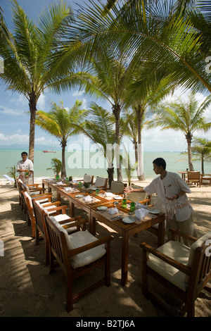 Waiters setting the table in a beach restaurant, Mae Nam Beach, Hat Mae Nam, Ko Samui, Thailand Stock Photo