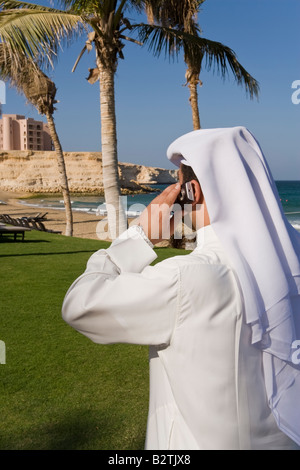 Middle East, Oman, Muscat, Al Jissah Shangri La Resort, man talking on a mobile phone Stock Photo
