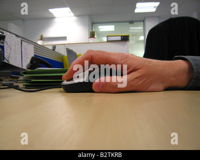 Businessmans hand on mouse on desk Stock Photo
