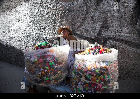 A local bolivian woman selling finger puppets near the witches market in La Paz, Bolivia. Stock Photo