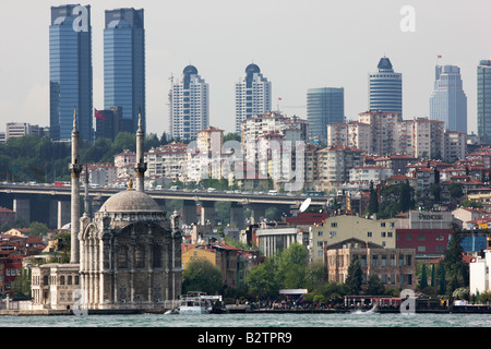 TUR Turkey Istanbul: Mecidiye mosque in the district of Ortaköy with the skyline of modern Istanbul Stock Photo