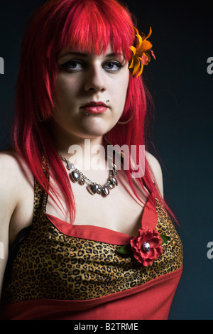 Headshot portrait of a young goth girl with dyed red hair. Stock Photo