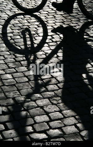 bike shadow on cobbled street road in city town
