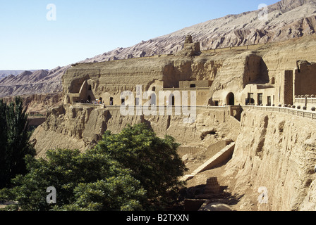 Thousand Buddha caves Gorge valley in Flaming mountains area Entrances terraces Red brown colours BEZEKLIK XINJIANG CHINA Stock Photo