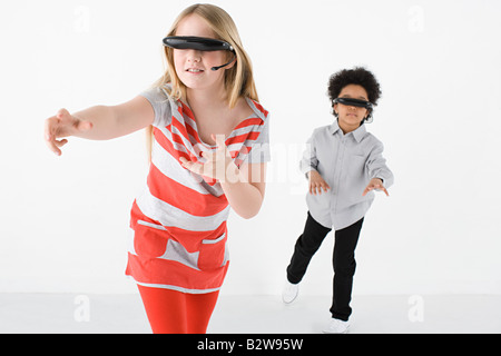 Kids wearing virtual reality headsets Stock Photo